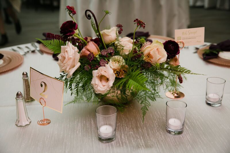 gold metallic bowl with pink and burgundy floral centerpieces