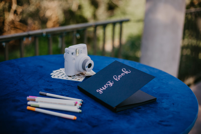 Polaroid camera and pens for a fun wedding guest book