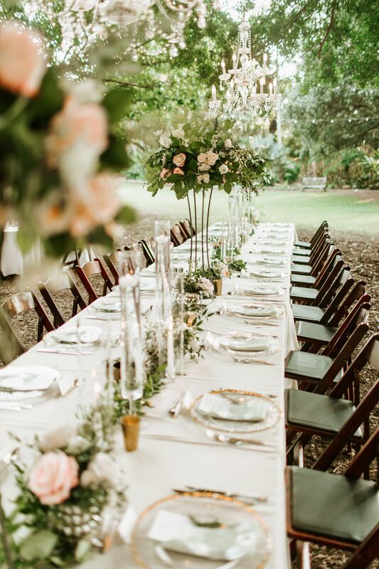 long feasting tables at an outdoor wedding reception at Marie Selby Botanical Gardens in Sarasota Florida