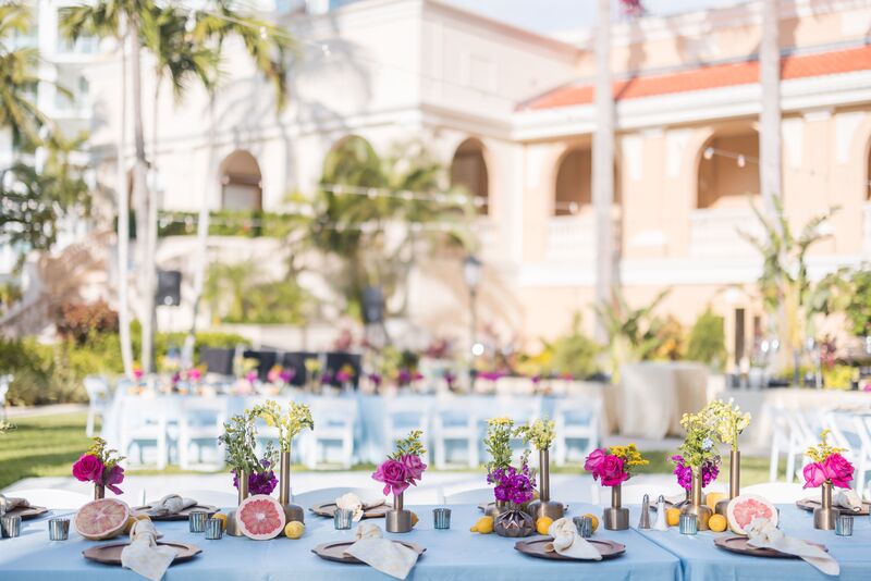 long tables draped in soft seafoam linens with brightly colored florals and citrus for a Sangget at the Ritz Carlton Sarasota
