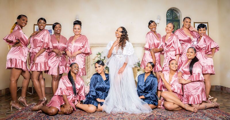 Bride and wedding party in robes posing for photos at Powell Crosley Estate