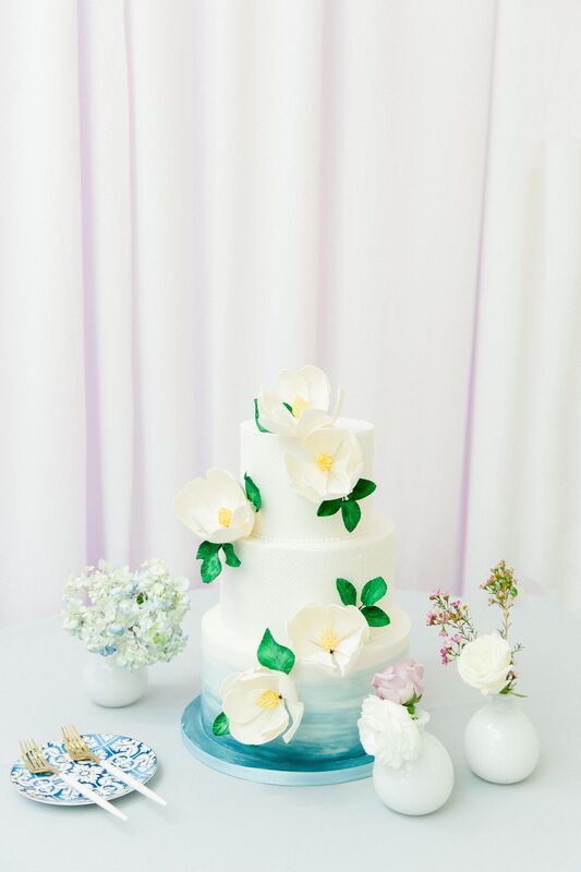 ombre blue and white wedding cake with sugar flowers