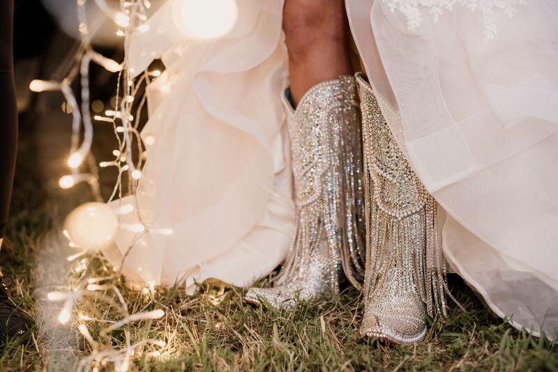 bride wearing sparkling rhinestone cowboy boots under her wedding gown