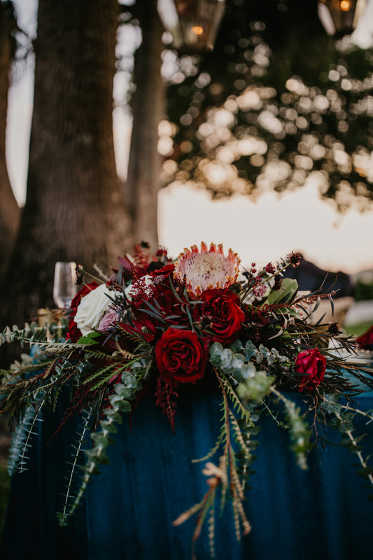 sweetheart table filled with richly textured flowers