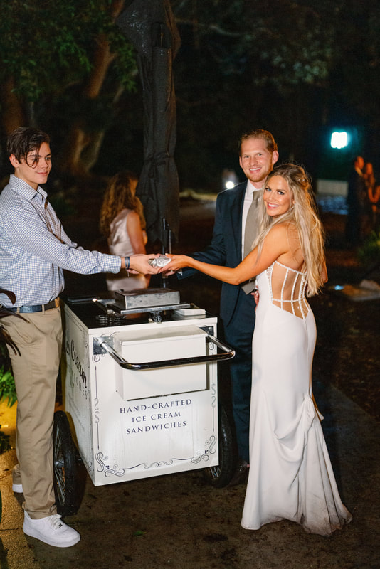 bride and groom getting dessert at Nye's Cream Sandwiches' cart at their Sarasota wedding reception