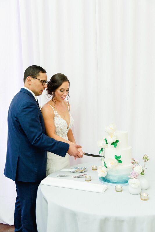 bride and groom cutting ombre wedding cake 