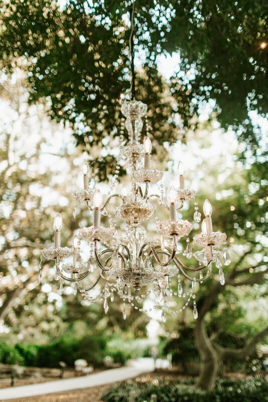 crystal chandelier hanging from trees at a Selby Gardens outdoor wedding reception