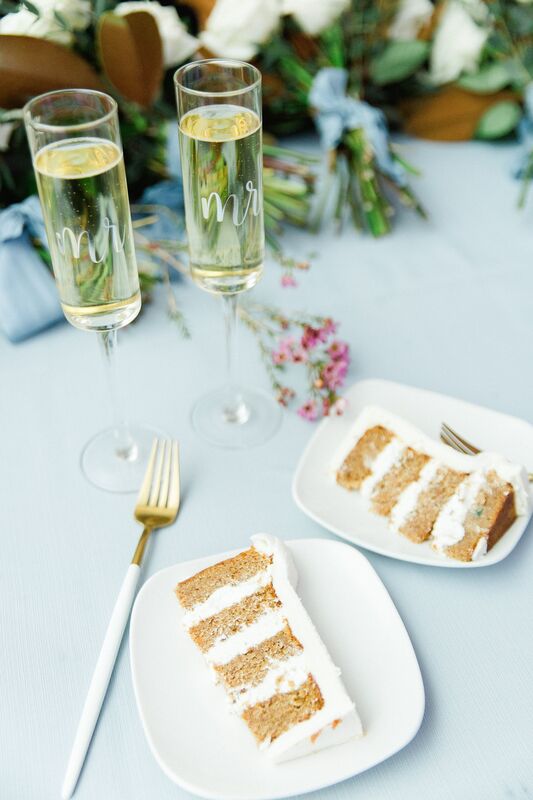 wedding cake slices with glasses of champagne