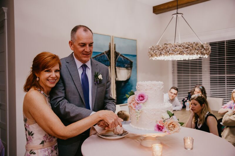 bride and groom cutting their wedding cake at their intimate Siesta Key wedding