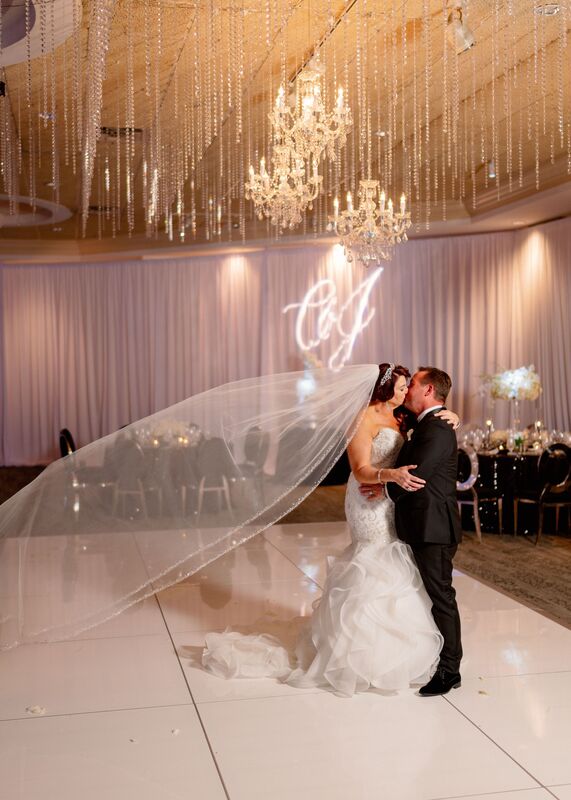 bride and groom dancing during their first look at their elegant black and white themed Sarasota wedding reception