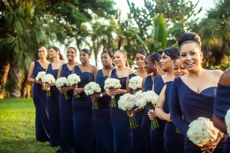 Bridesmaids dressed in navy blue dresses looking on as the bride comes down the aisle at Powell Crosley Estate