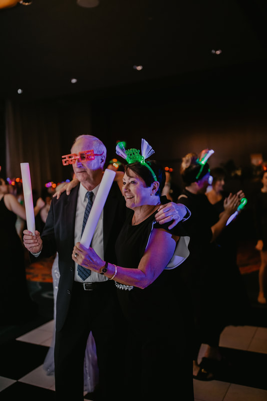 Wedding guests with light sabers and New Year's Eve toys