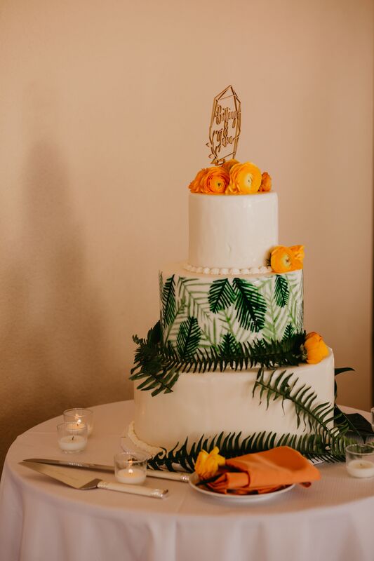 Three tiered tropical inspired wedding cake with lemon custard and raspberry mousse
