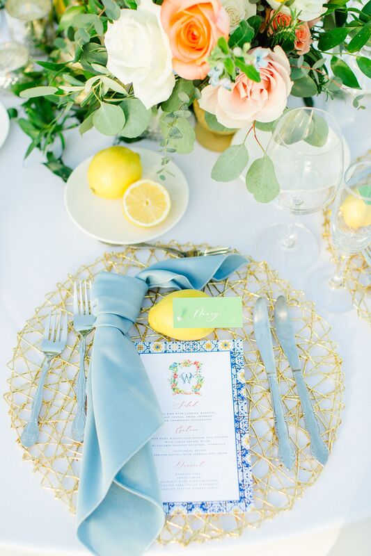 Bright blue, pink and yellow tablescape with lemons for an Italian inspired wedding reception