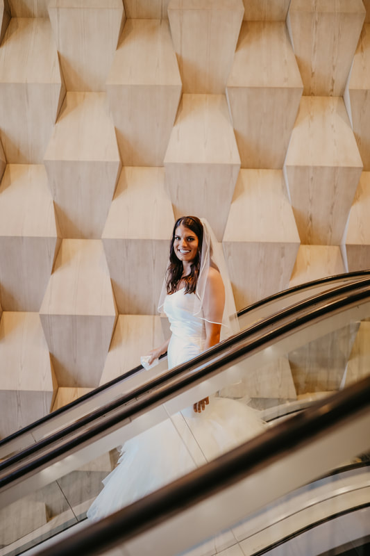 bride on the escalator of the Opal Sands Resort