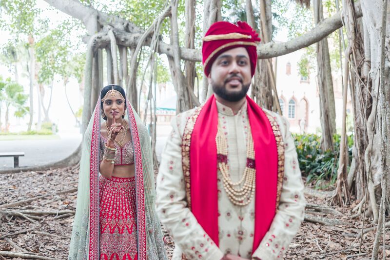 South Asian bride walking up behind her groom for their first look