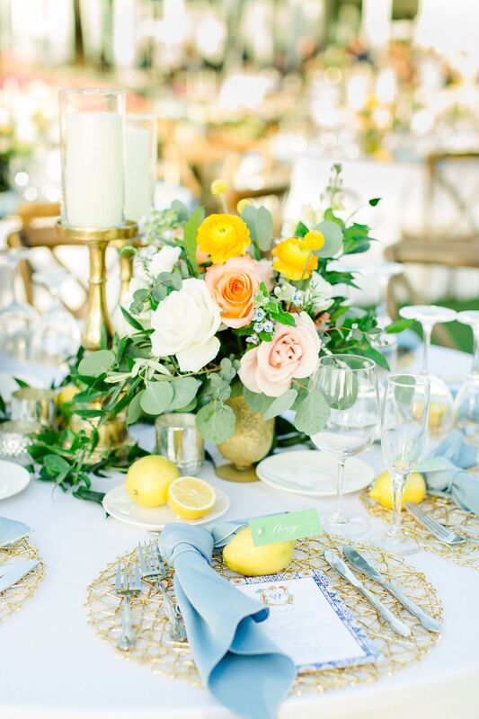 Bright blue, pink and yellow tablescape with lemons for an Italian inspired wedding reception