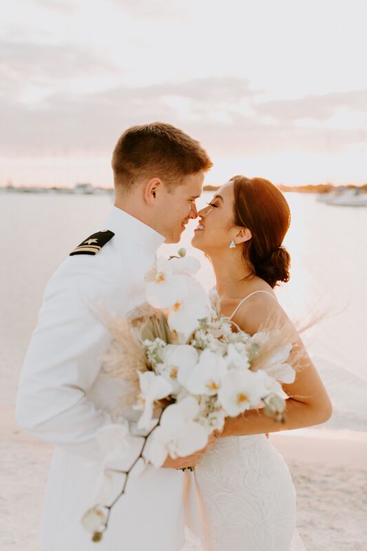 Military groom and his new bride on the waterfront after their Tampa wedding