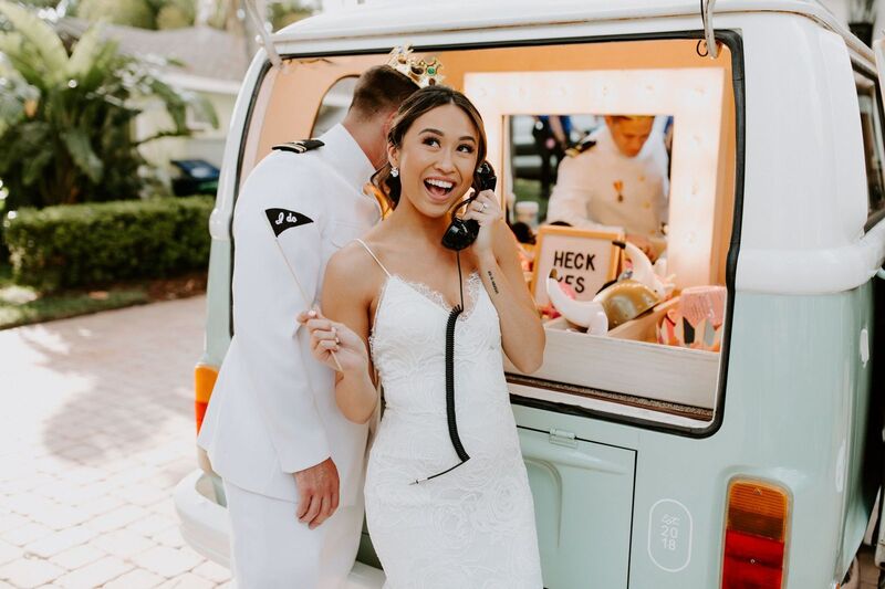 Bride and groom having fun with their photo booth bus