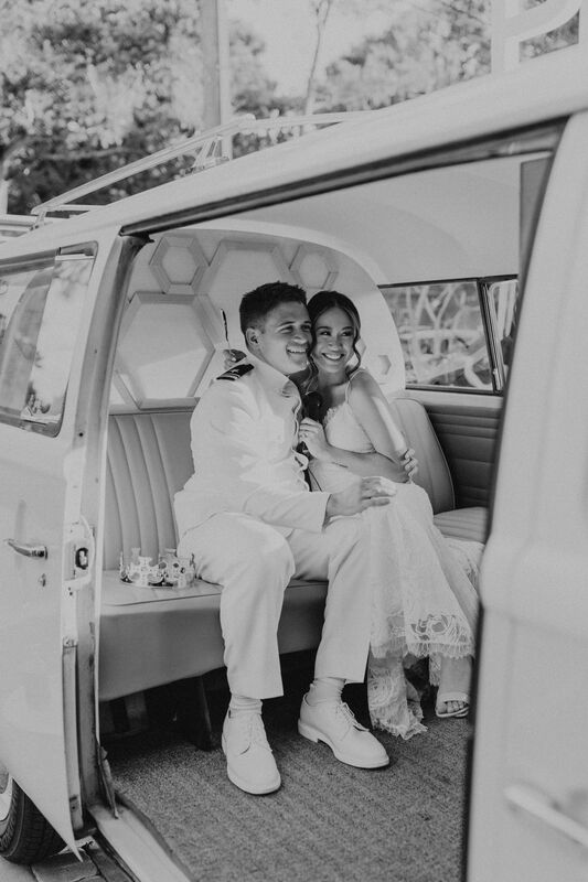 bride and groom inside their photo booth bus