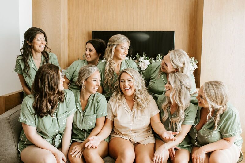 bride sitting on the bed with her bridal party
