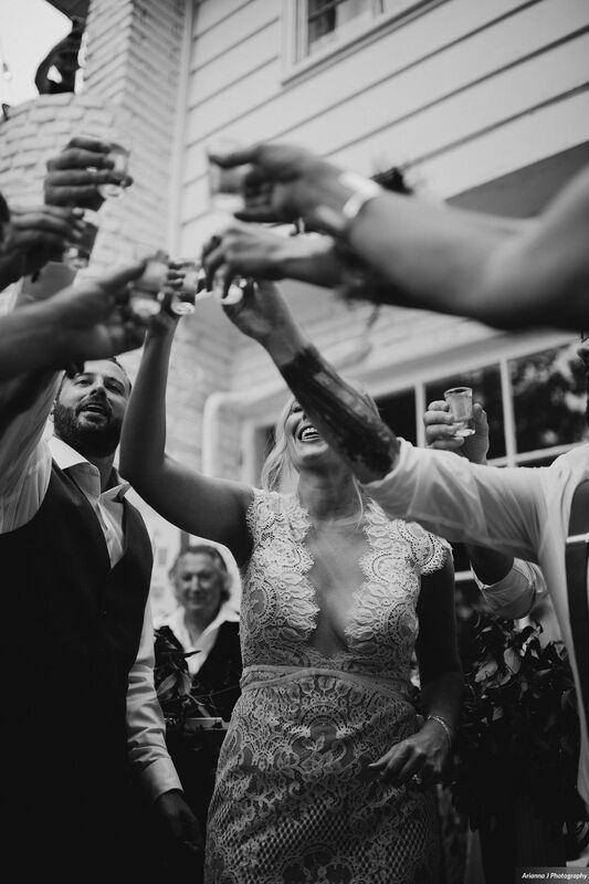 Bride and groom toasting with their wedding party after their wedding ceremony