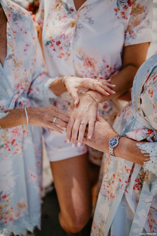 bride showing her engagement ring to her wedding party