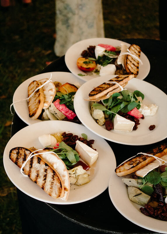 individual artisan cheese and charcutery plates at a Powel Crosley tented wedding reception in Sarasota