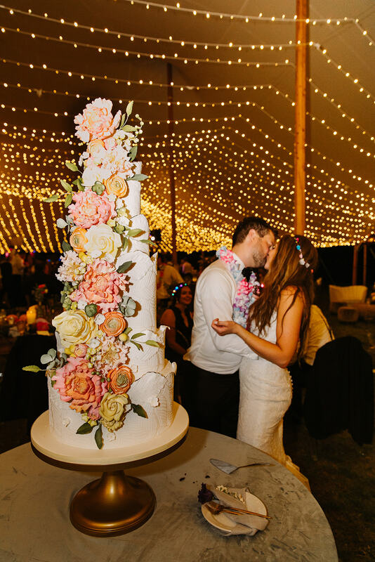 bride and groom kissing after cutting thier edding cake