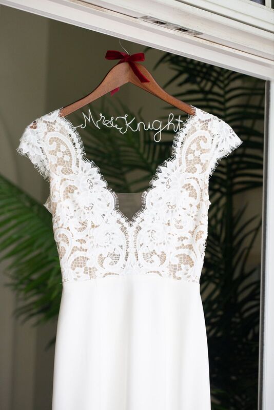 boho inspired illusion lace wedding gown on a custom hanger with brides name