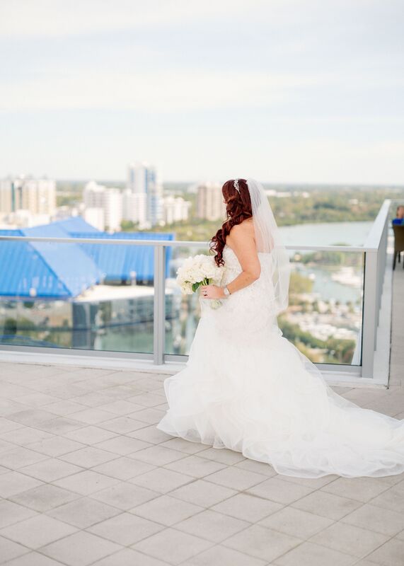 bride walking across the rooftop of the Westing Sarasota to see her groom-to-be