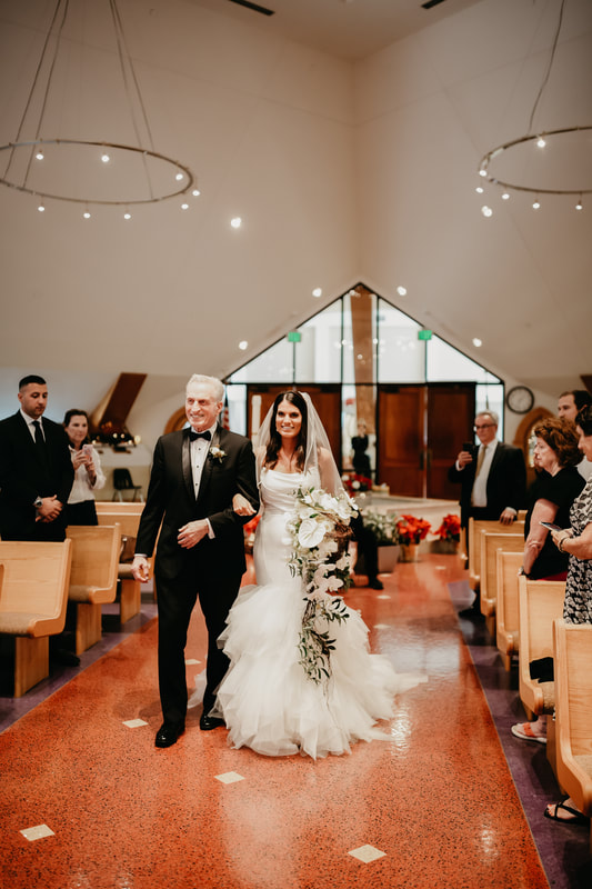Bride walking down the aisle with her father at St Jerome Cathlic Church