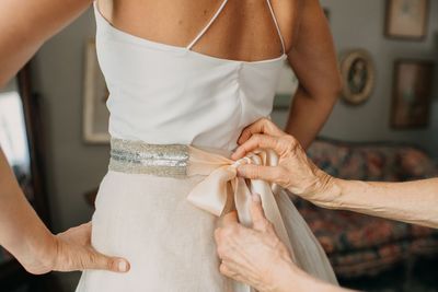 Jennifer Matteo Event Planning – Sarasota Wedding Planner- Selby Garden Wedding -rustic garden wedding -bride getting dressed - custom wedding gown