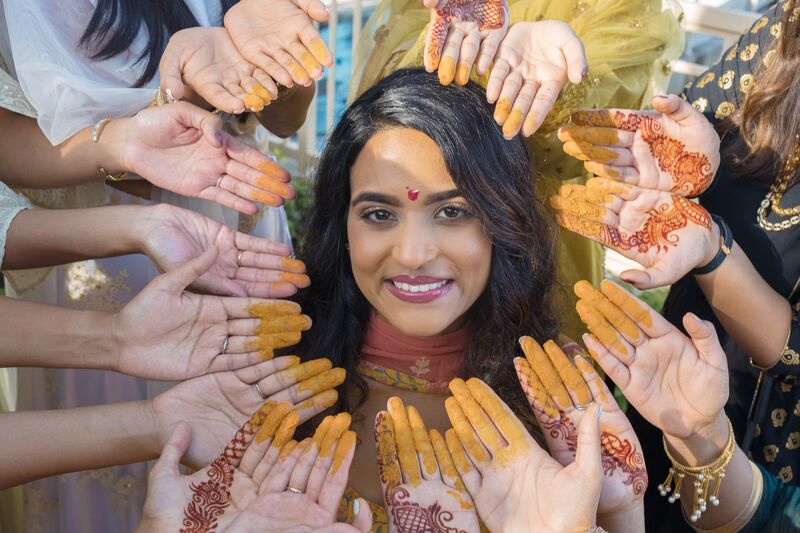 South Asian bride covered with tumeric during a Haldi ceremony at the Ritz Carlton Sarasota