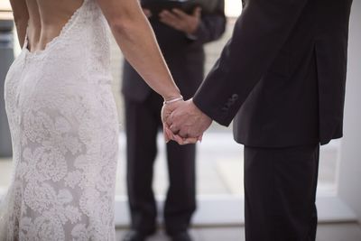 Jennifer Matteo Event Planning  - Sarasota wedding planner- Westin Sarasota – rooftop wedding-bride and groom holding hands