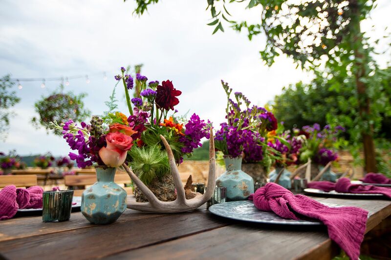 rustic wooden table with colorful centerpieces