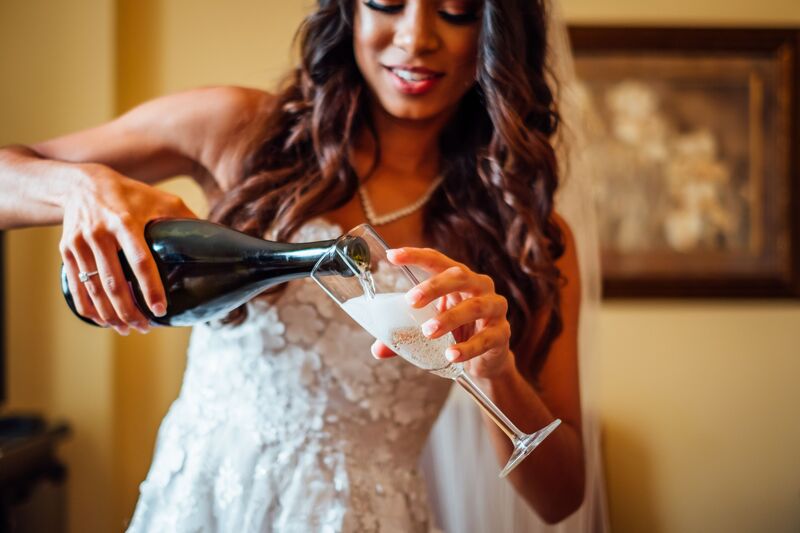 Lakeland wedding – Magnolia Building – Florida Wedding Planner – Jennifer Matteo Event Planning. – Lakeland wedding planner - bride - bride pouring champagne