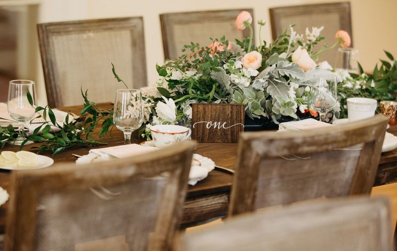 Jennifer Matteo Event Planning – Sarasota wedding planner – Edson Keith Mansion – Sarasota weddings- Edson Keith wedding - rustic wood tables - wedding reception with long wooden tables - peach and pink centerpieces - centerpieces with dusty miller