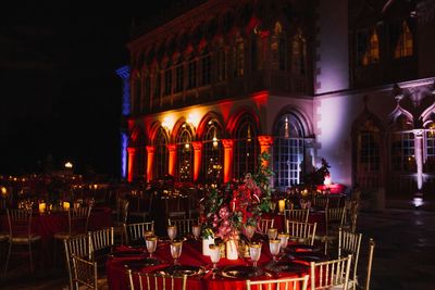 Jennifer Matteo Event Planning – Sarasota Wedding Planner – Florida Luxury Wedding Planner – Ringling Wedding – Sarasota Wedding - Ringling outdoor wedding reception - red wedding lighting