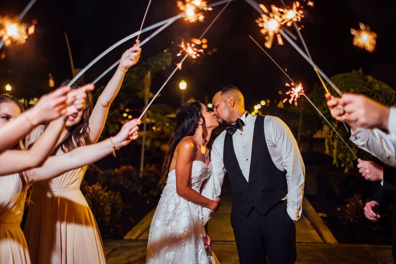Lakeland wedding – Magnolia Building – Florida Wedding Planner – Jennifer Matteo Event Planning. – Lakeland wedding planner - bride and groom kissing - sparklers at wedding - grand exit - sparkler exit